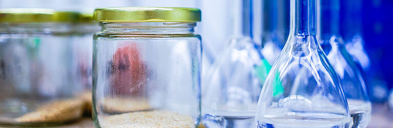 Glass with cereals and laboratory utensils